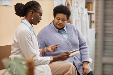 A participant going through study paperwork with a doctor