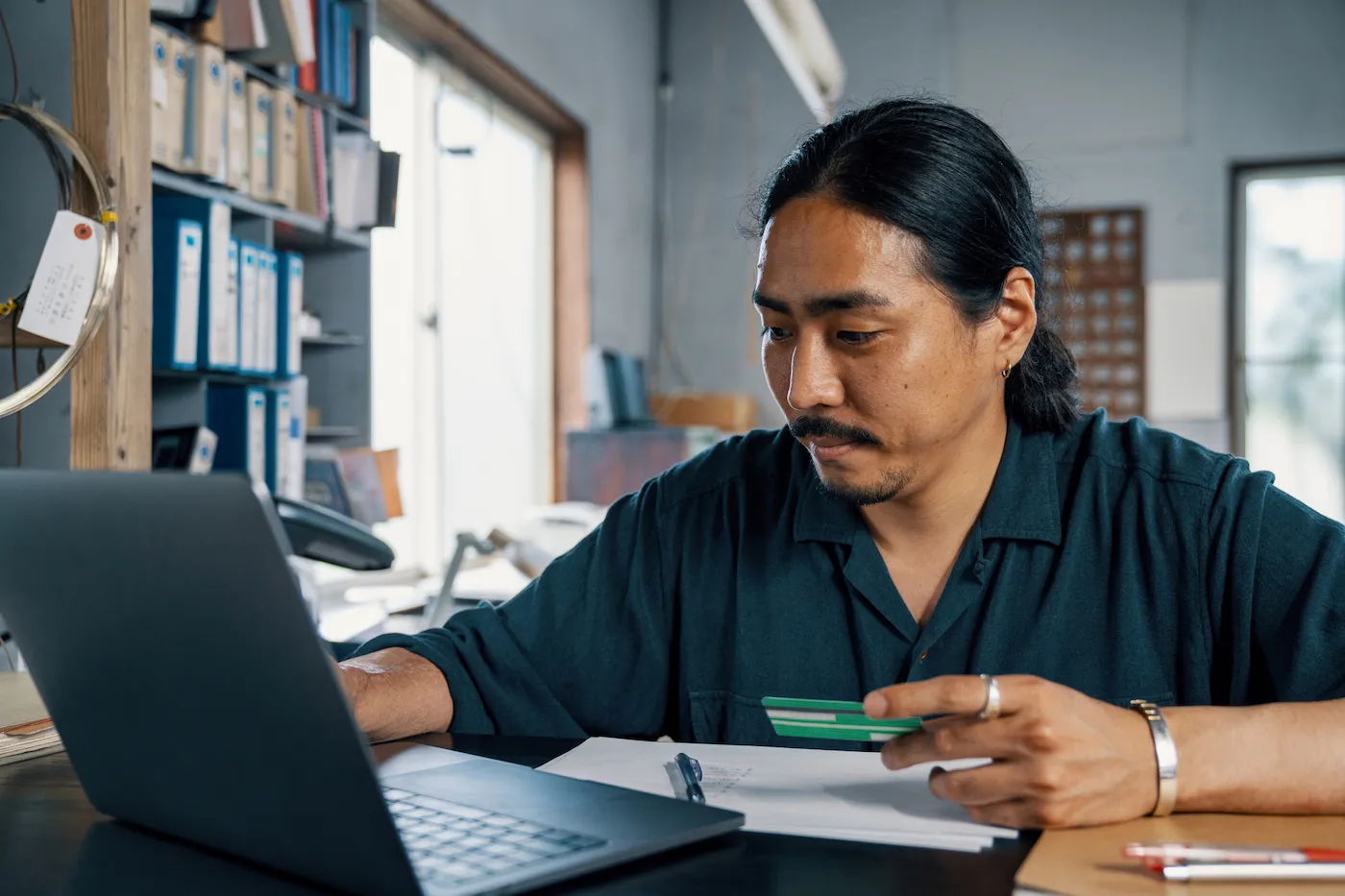 A participant checking a study payment at his desk